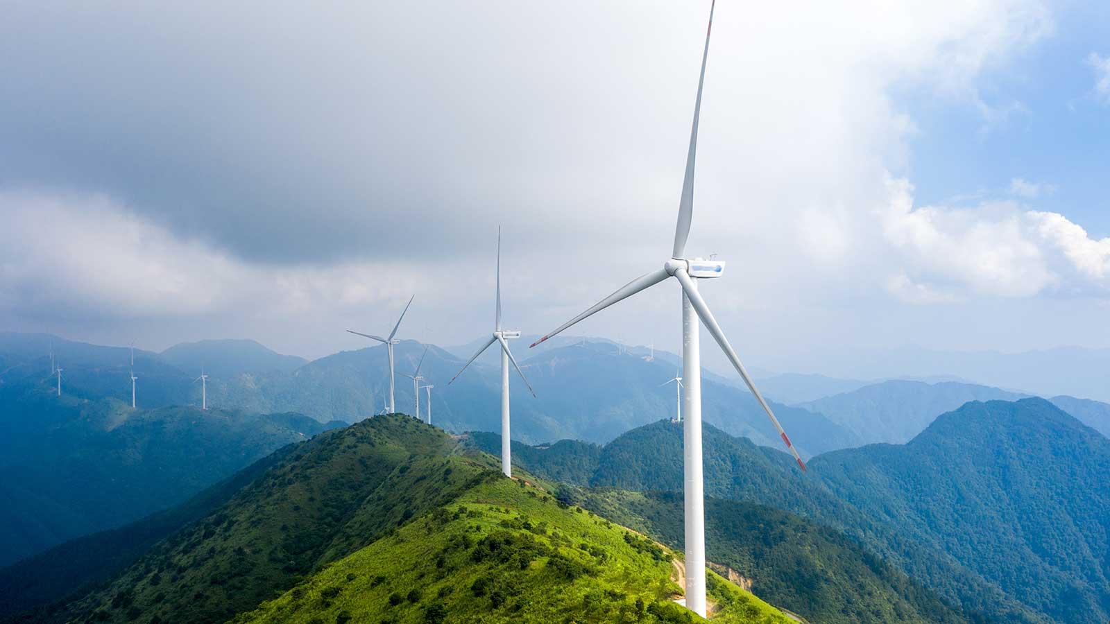 Wind turbines on hilltops representing Business Energy Advanced Certificates at Clarkson University