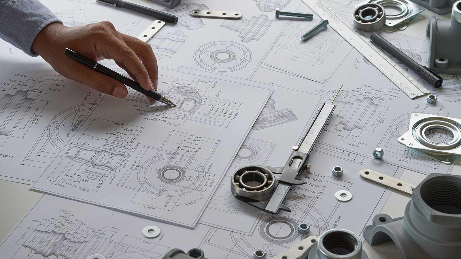 Mechanical engineer looking at blueprints representing mechanical engineering program at Clarkson university 